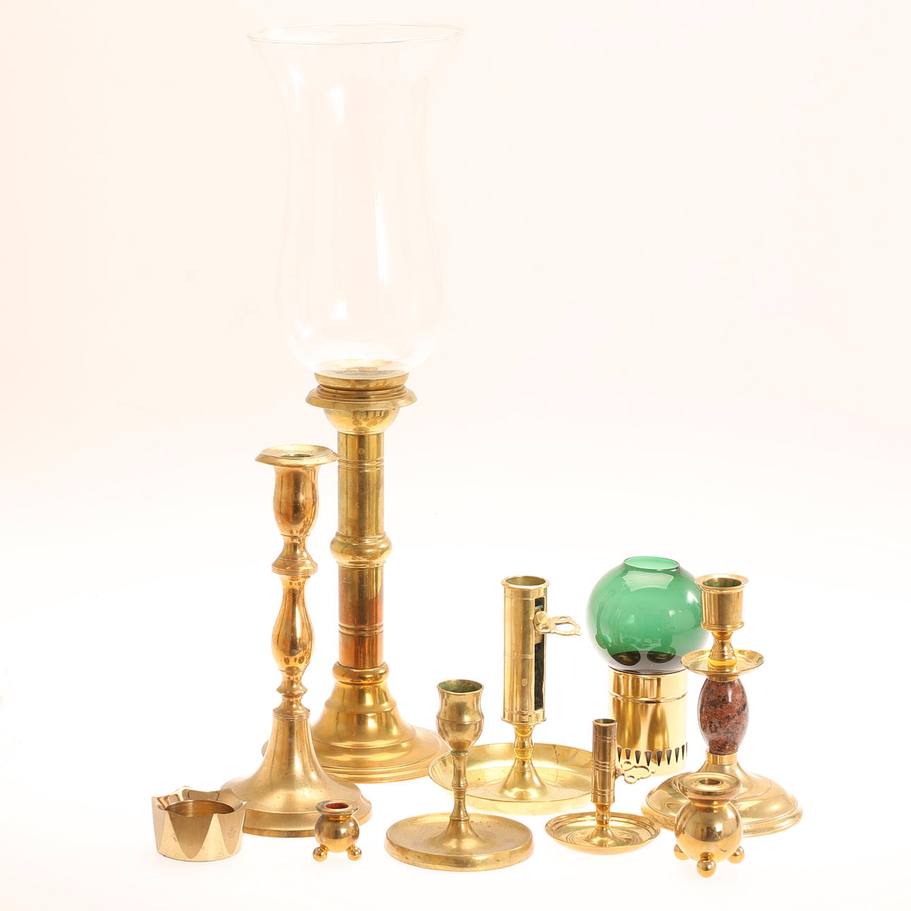 Brass candlesticks, 7 pieces, and storm lantern 20th century.