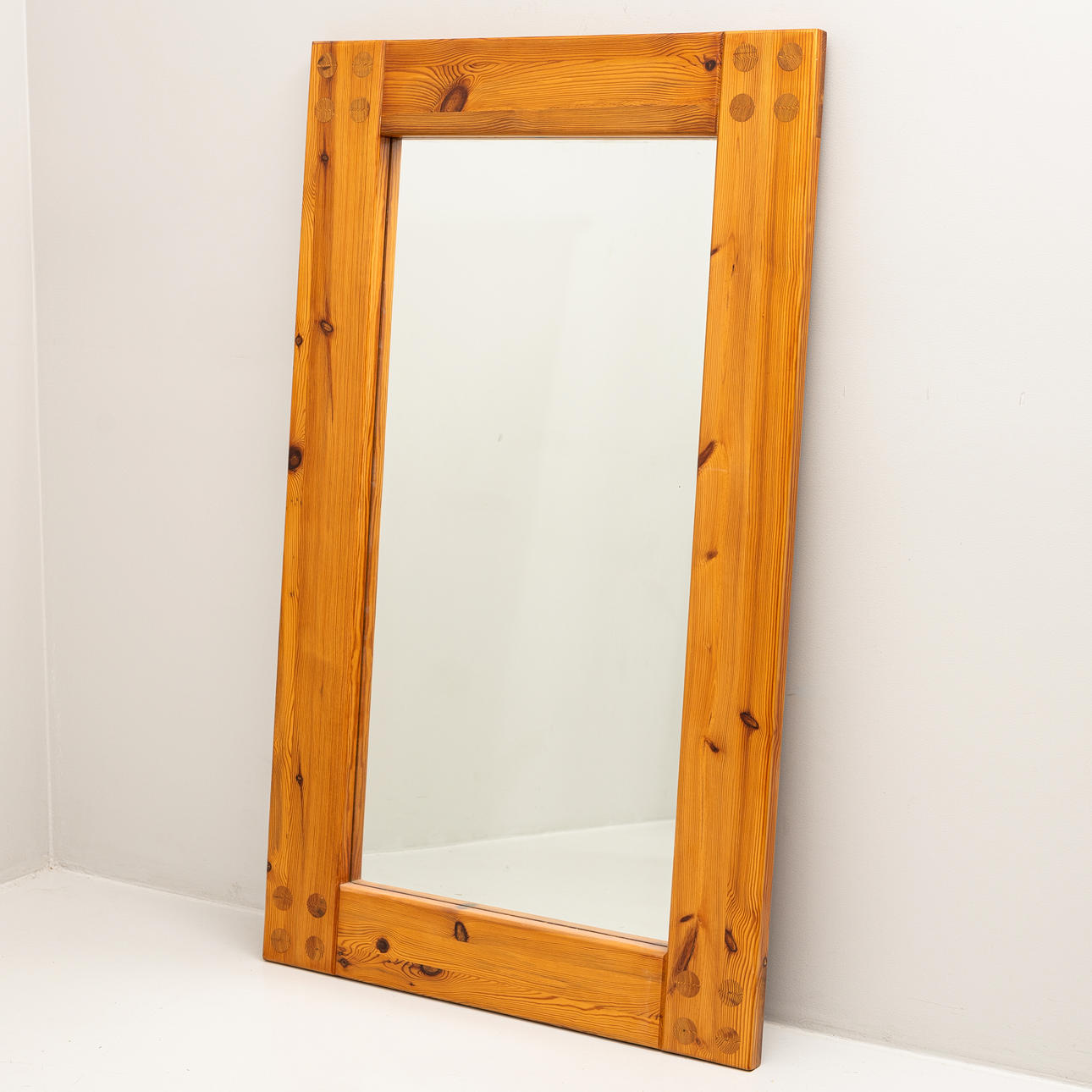 A 20th century solid pine mirror.