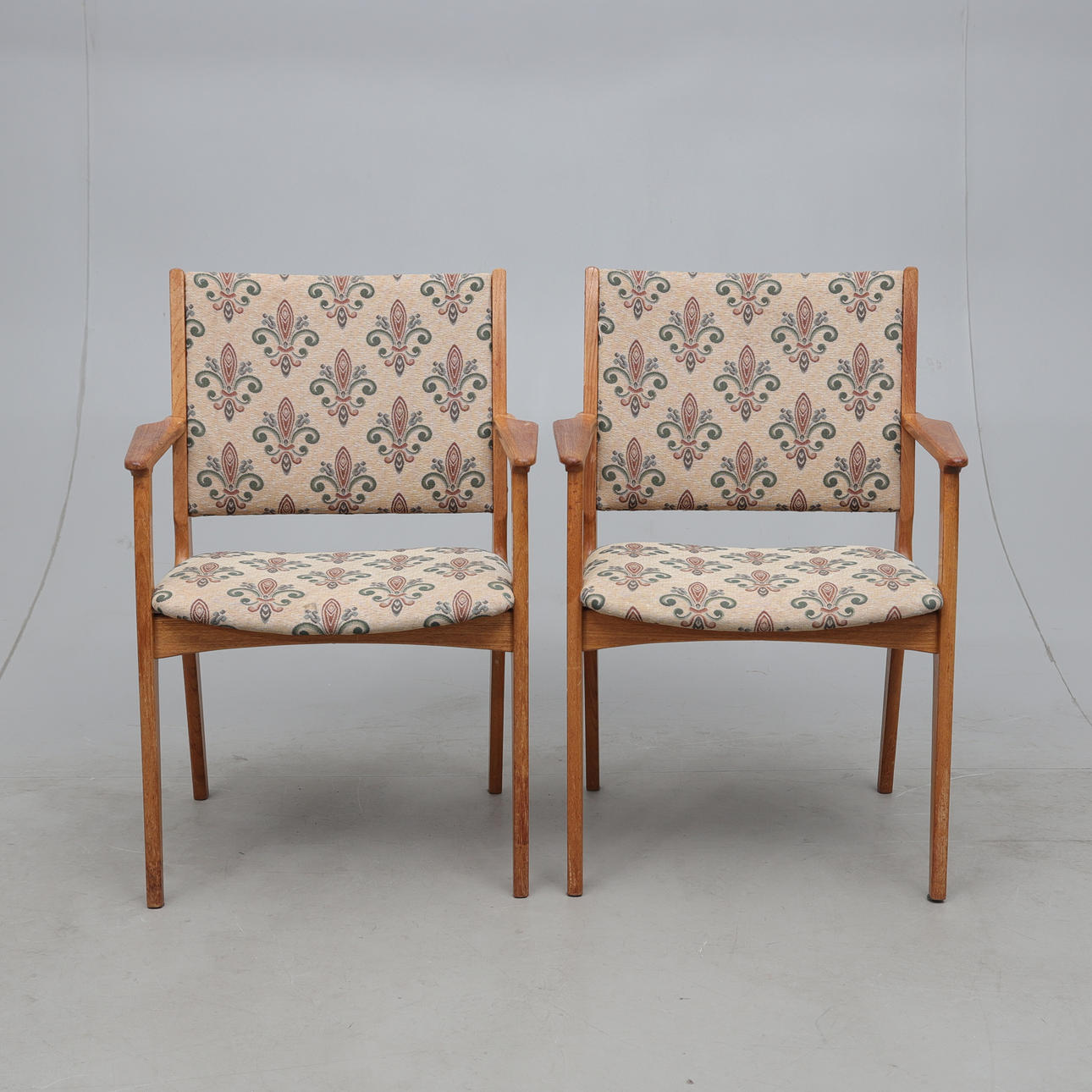 A pair of mid 20th century solid teak armchairs.