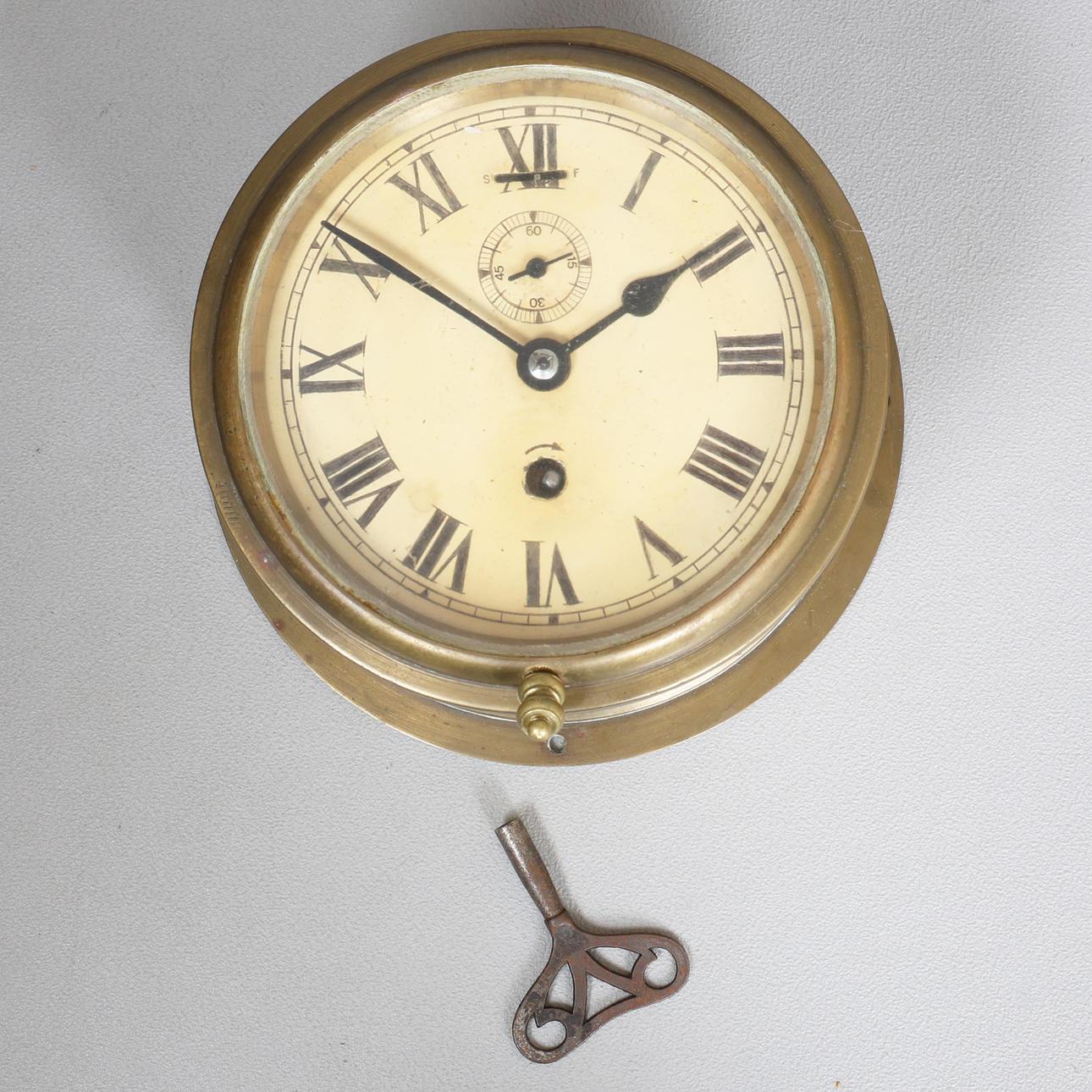 A BRASS CASED SHIPS BULKHEAD CLOCK.
