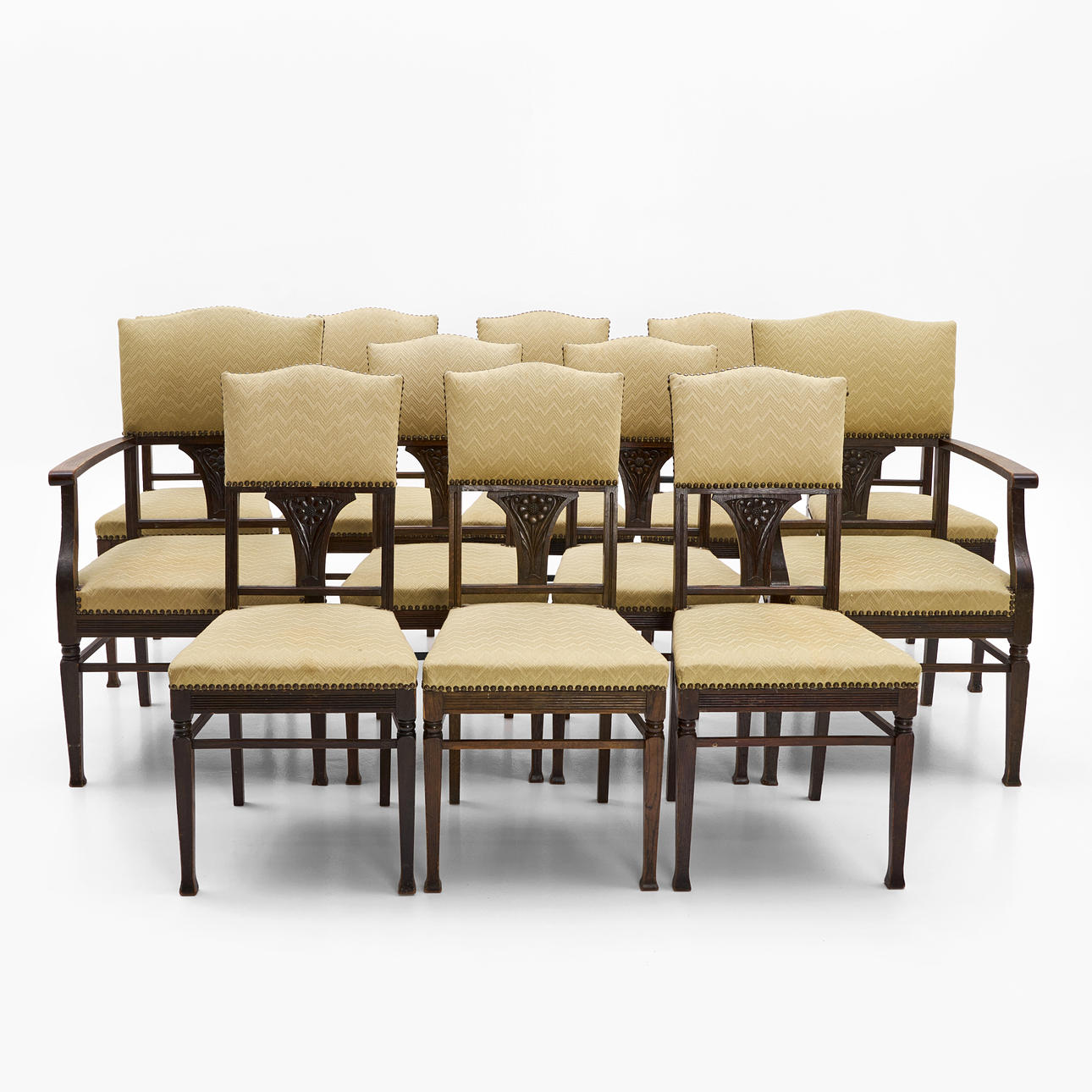 AB LINDELLS MÖBELFABRIK, Norrköping, first part of the 20th century, 12 dlr, consisting of 10 chairs, 2 armchairs, Art Nouveau, carved decor in the form of flower, oak.