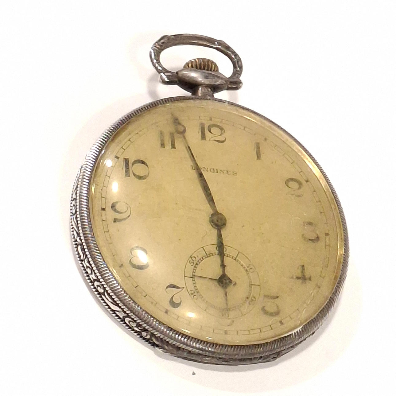 LONGINES. Guilloxé silver visible dial pocket watch.