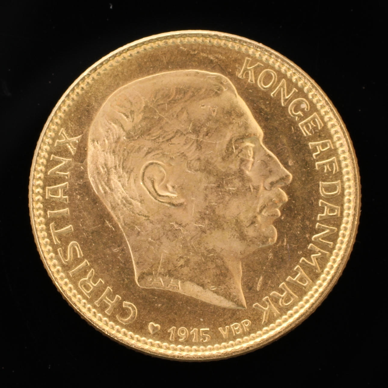 GULDMYNT, 21,6k guld, 20kr Christian X Danmark 1915.