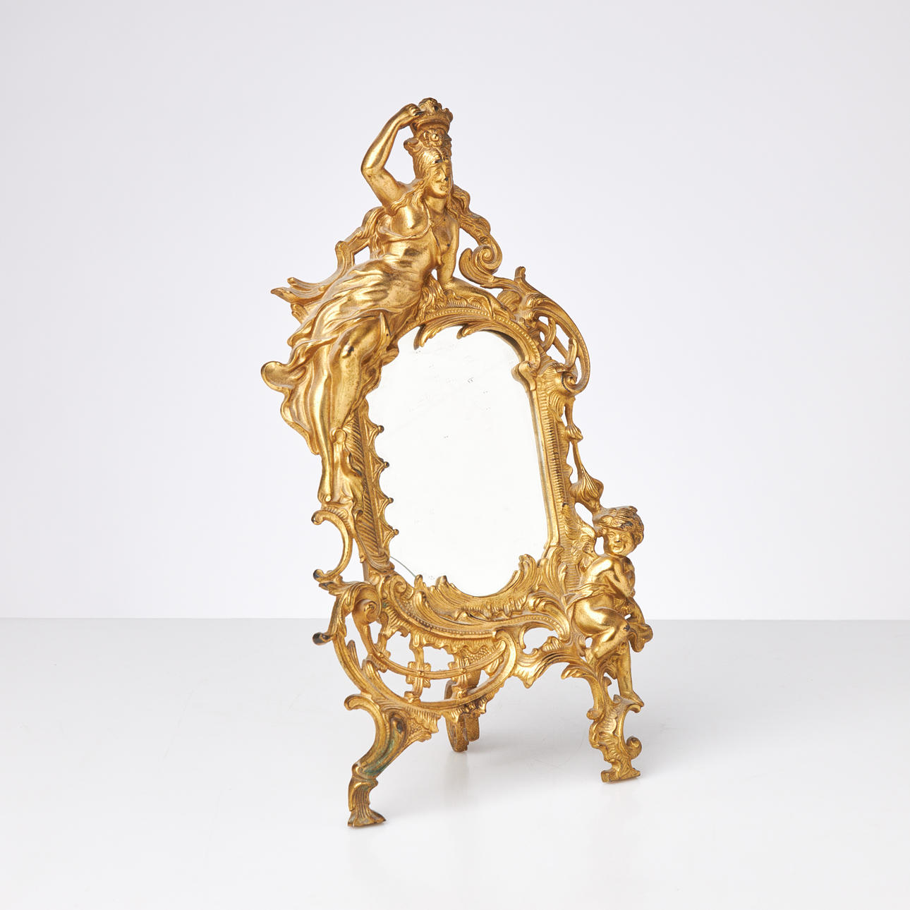 TABLE MIRROR/FRAME, Rococo style, 20th century, gilt metal.