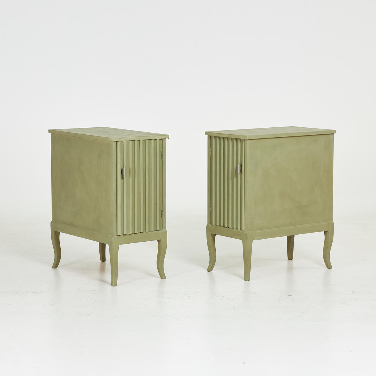 A pair of bedside tables, first half of the 20th century, fluted decor, later painted.