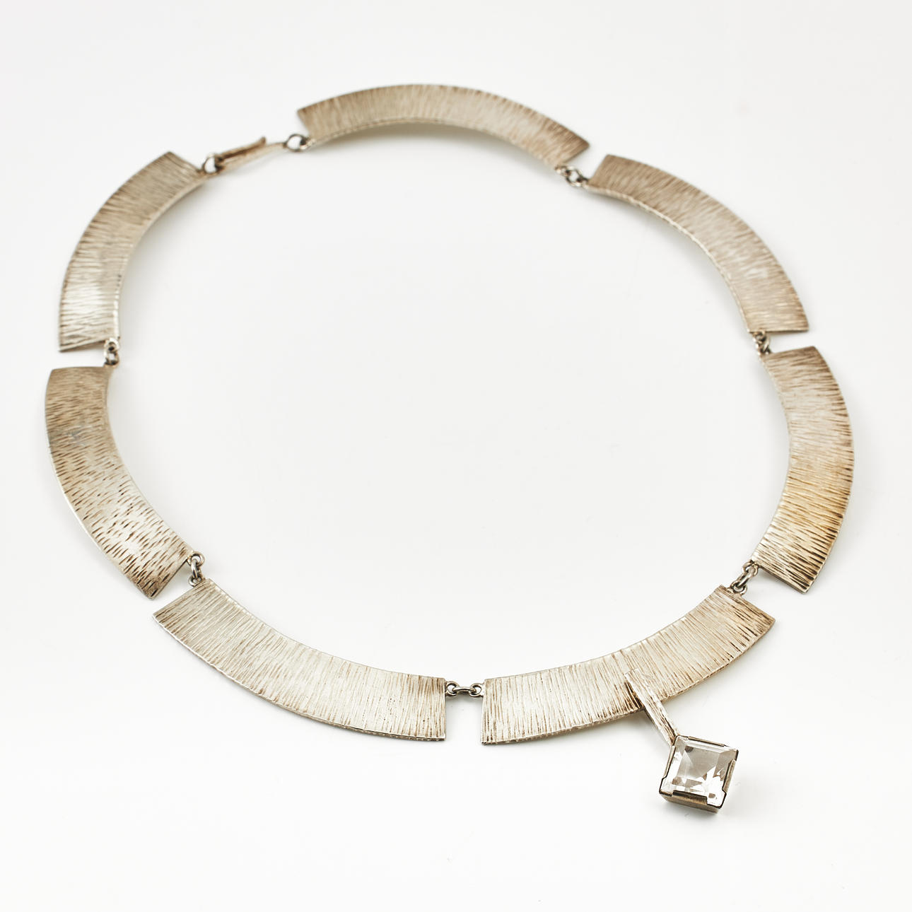 NECKLACE WITH PENDANT, sterling silver, 7 interconnected plates with fluted decor and center part with removable pendant with stair-cut white stone, Silverhuset i Halmstad AB, Halmstad 1985/1986.