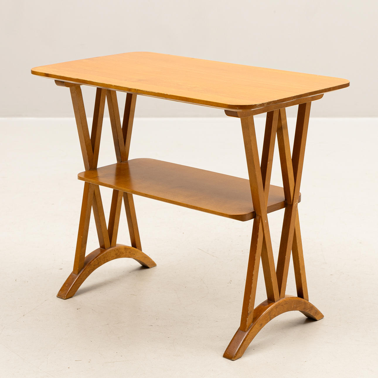 A 1940s-era bedside table/newspaper table, boned wood.