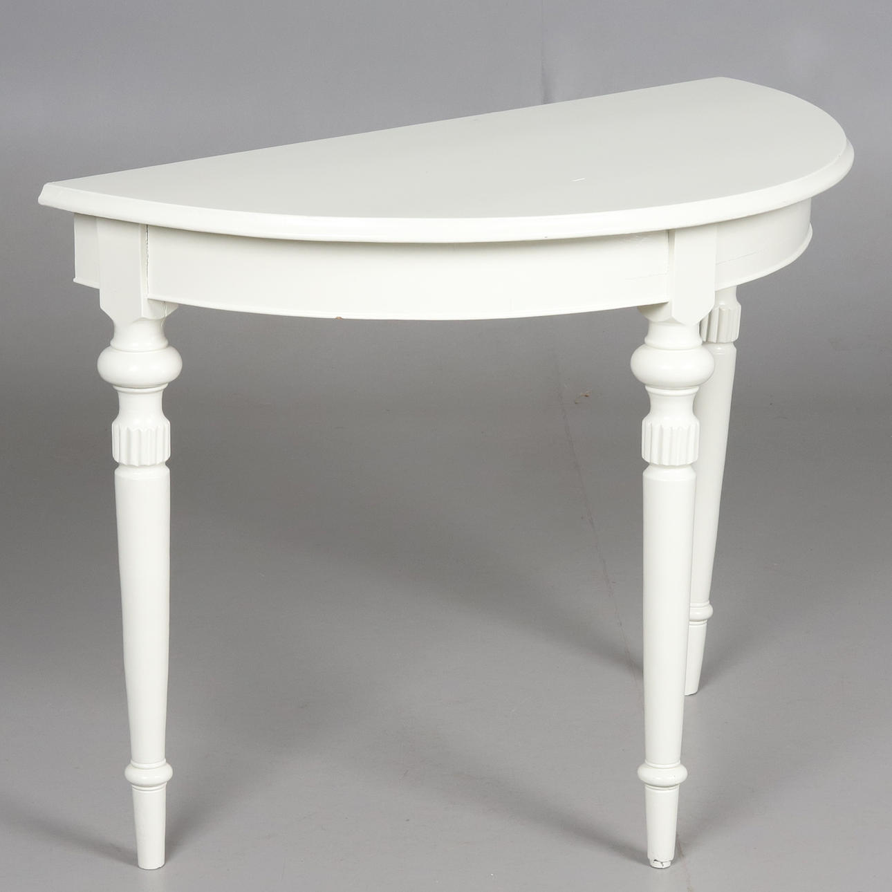 A half-moon table, painted wood, 20th century.