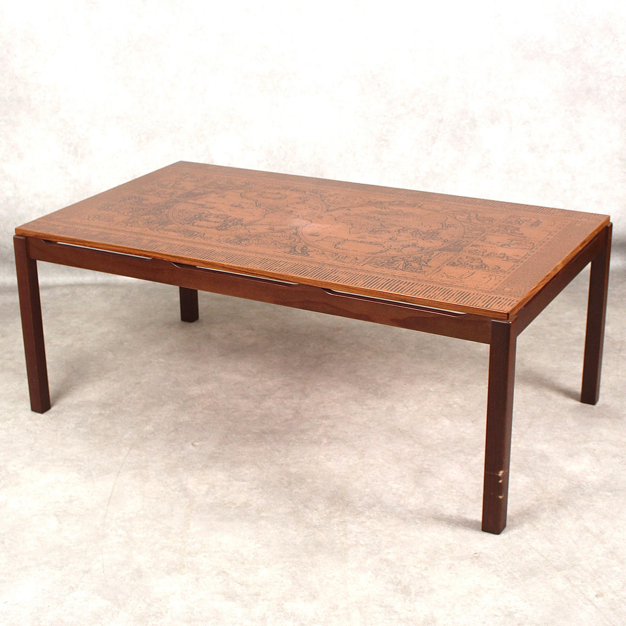 A 1970s-century coffee table with copper top.