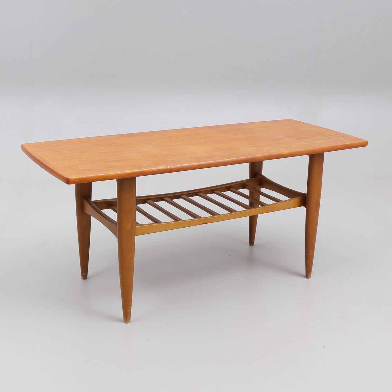 A teak coffee table with magazine shelf, 1950s/60s.