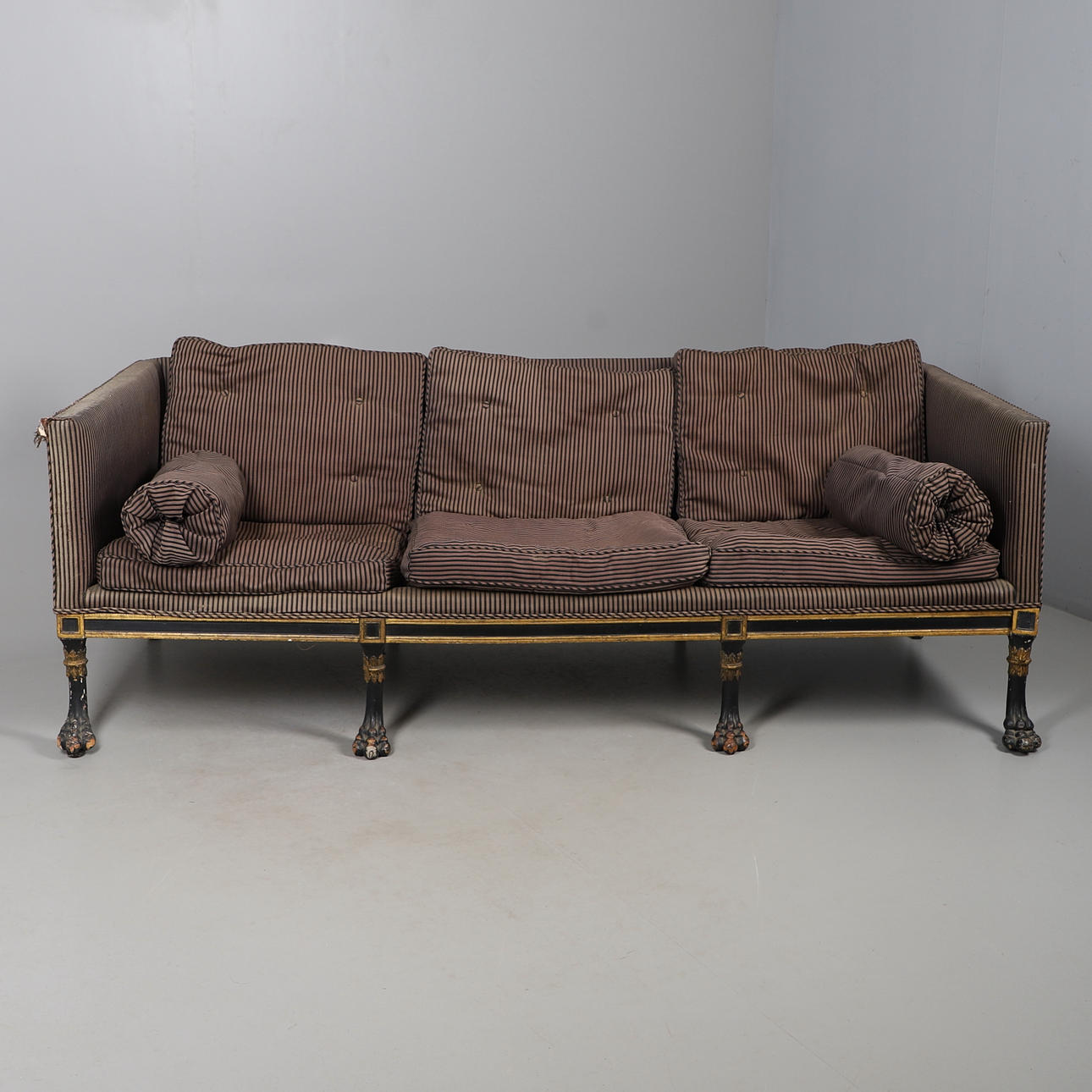 A REGENCY EBONISED AND GILT FRAME THREE SEAT SETTEE IN THE MANNER OF ...