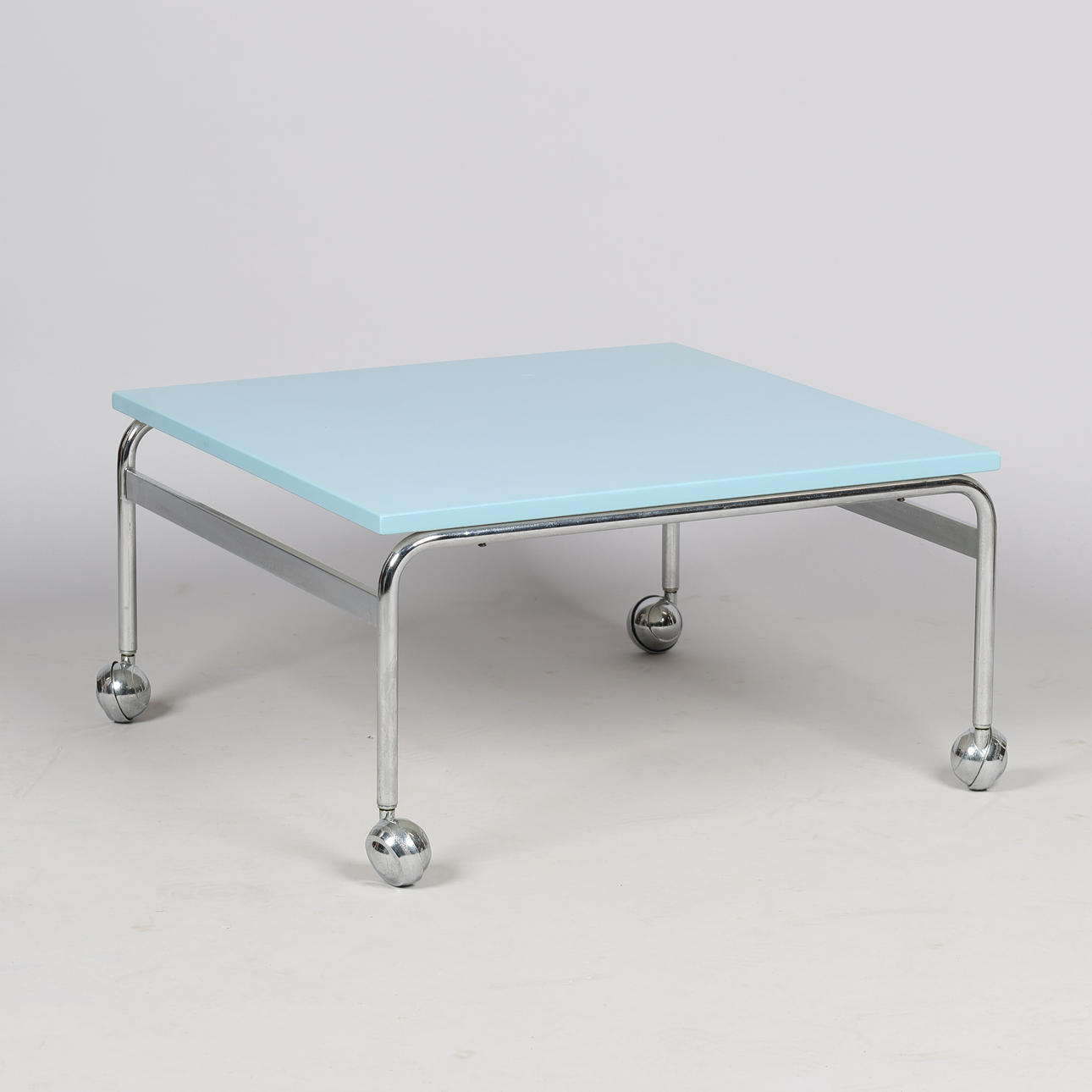 BRUNO MATHSSON. Couchtisch „Karin“ mit hellblauer Tischplatte und verchromtem Gestell auf Rädern, DUX, Schweden, zweite Hälfte des 20. Jahrhunderts.