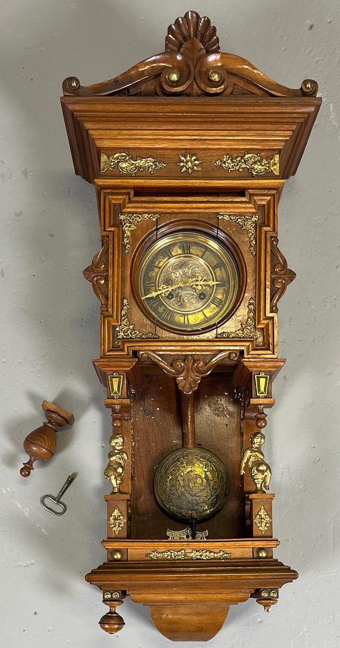 An oak wall clock, Schablonenuhr, Germany, circa 1900.