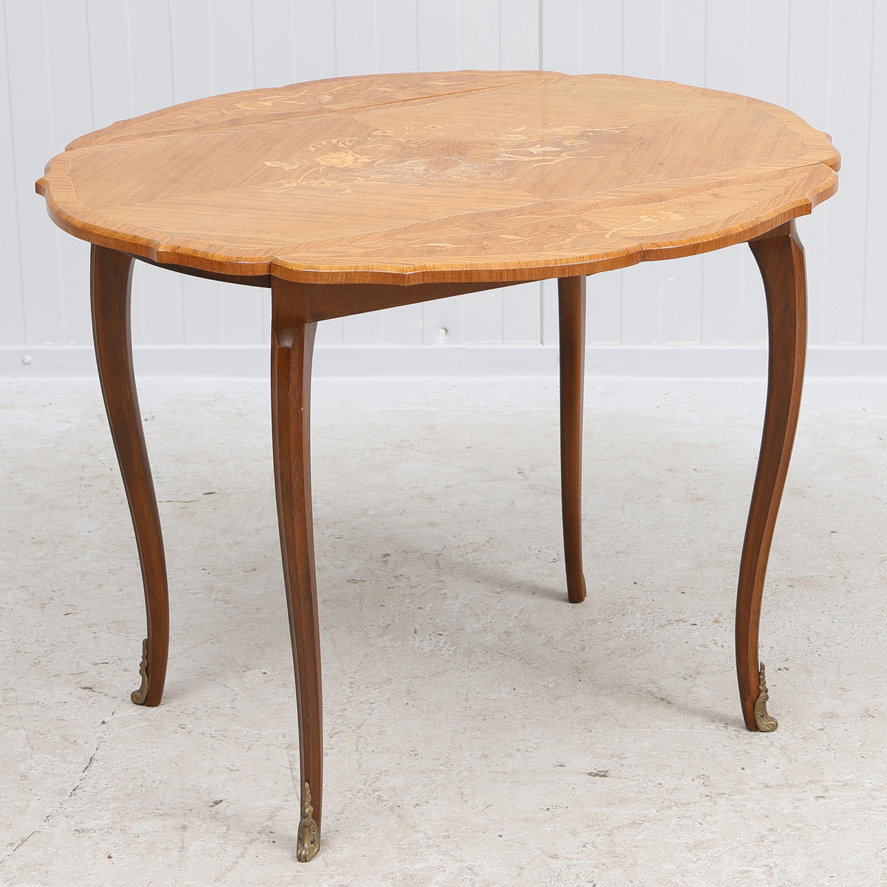 A 20th century Rococo Intarsia folding table.