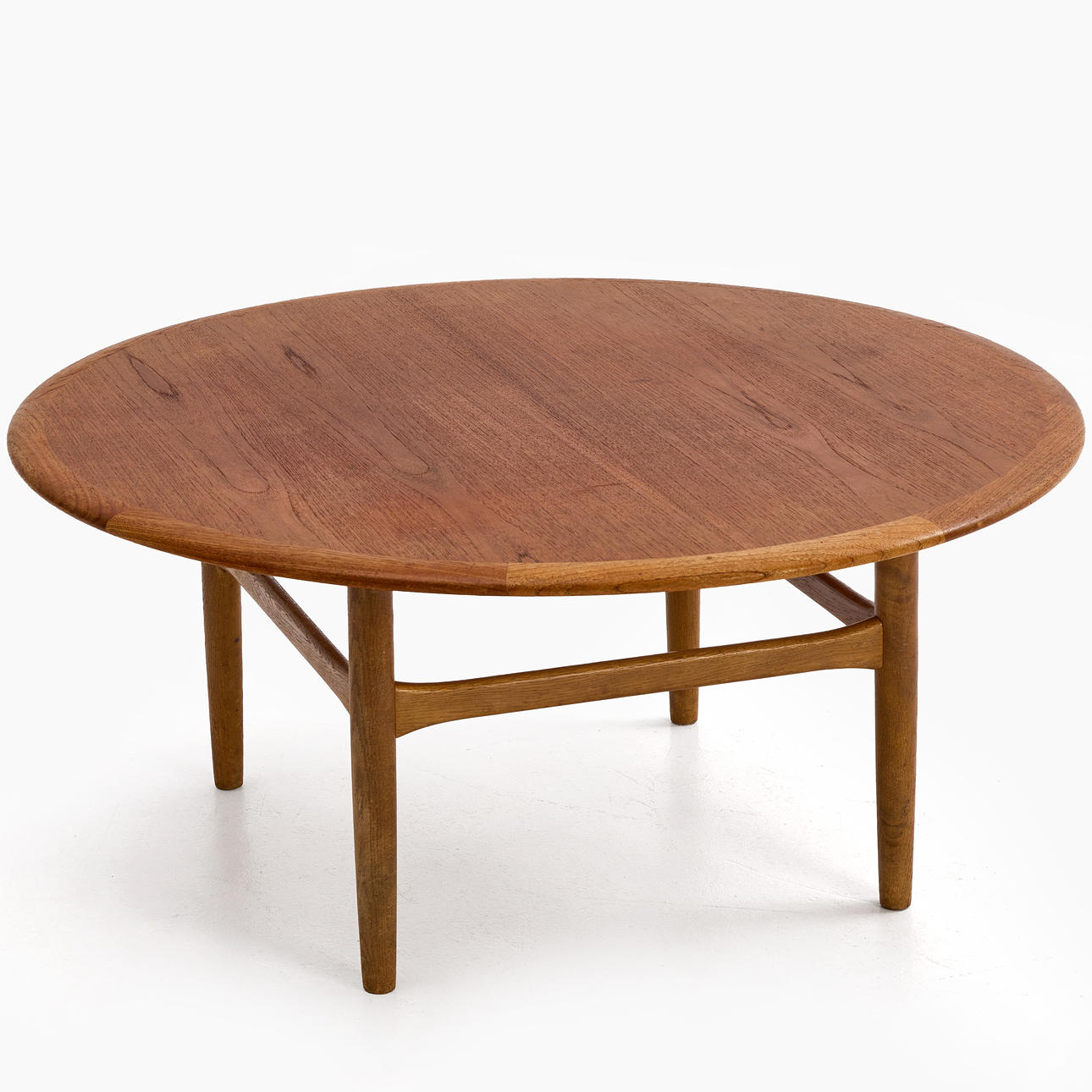 KURT ØSTERVIG. Circular teak coffee table, oak leg frame, No. 198, Jason Ringsted, Denmark, 1950s/1960s.