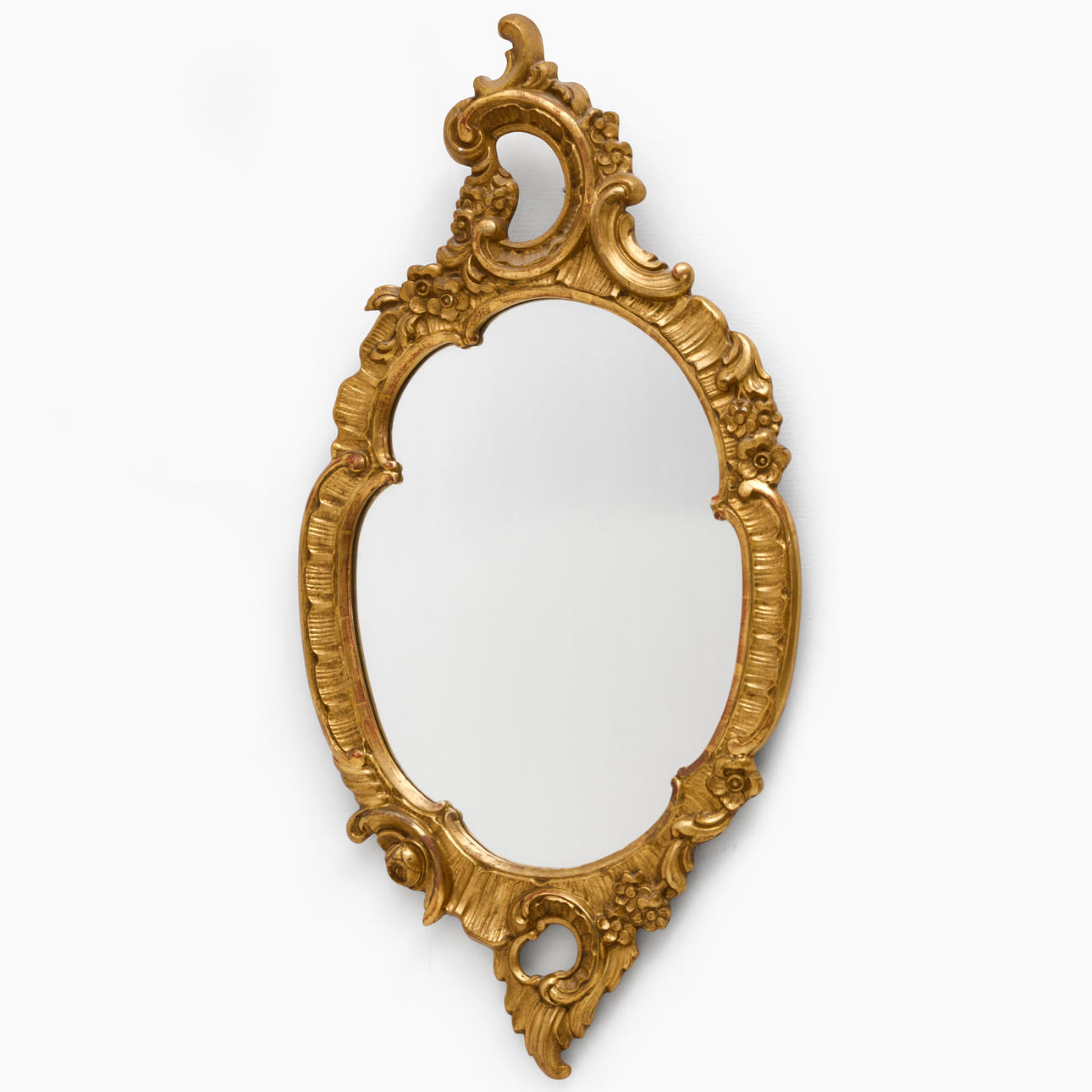 A rococo style mirror, gilt, partly bronzed, 20th century.