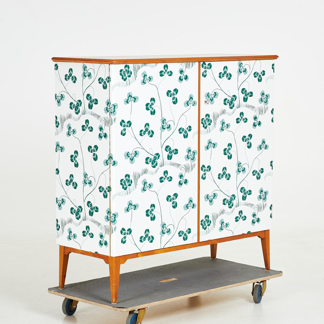 A serving cabinet, mid 20th century, upholstered with “Klöverblad” designed by Josef Frank.