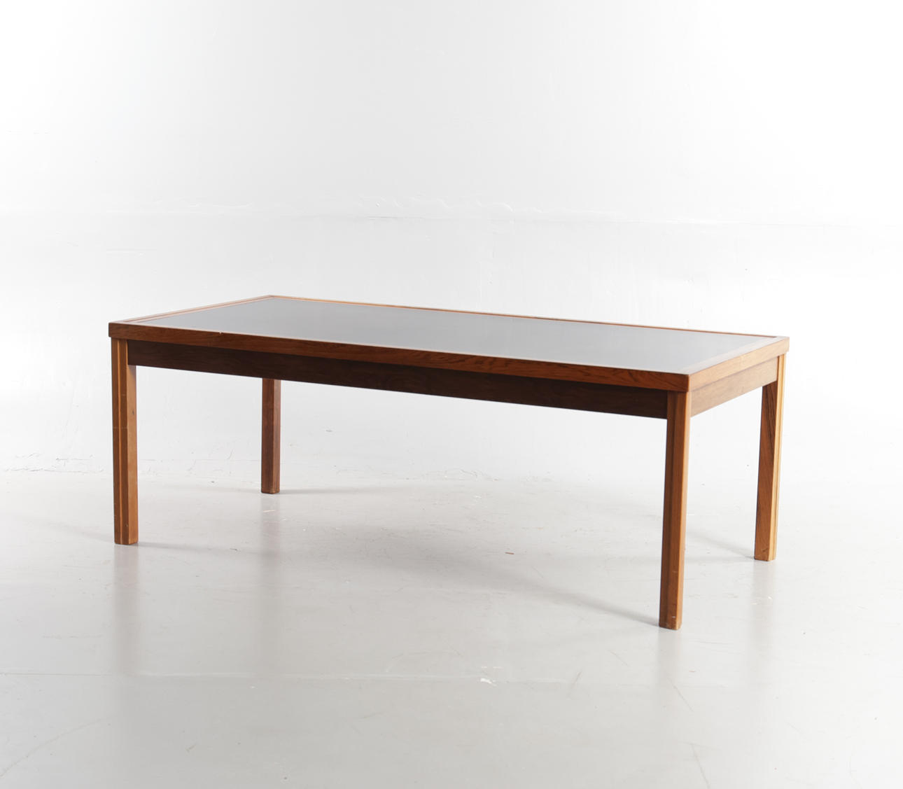 DANSK MØBELDESIGN. Rectangular rosewood coffee table, top coated with black formica. Denmark, 1960-70s.
