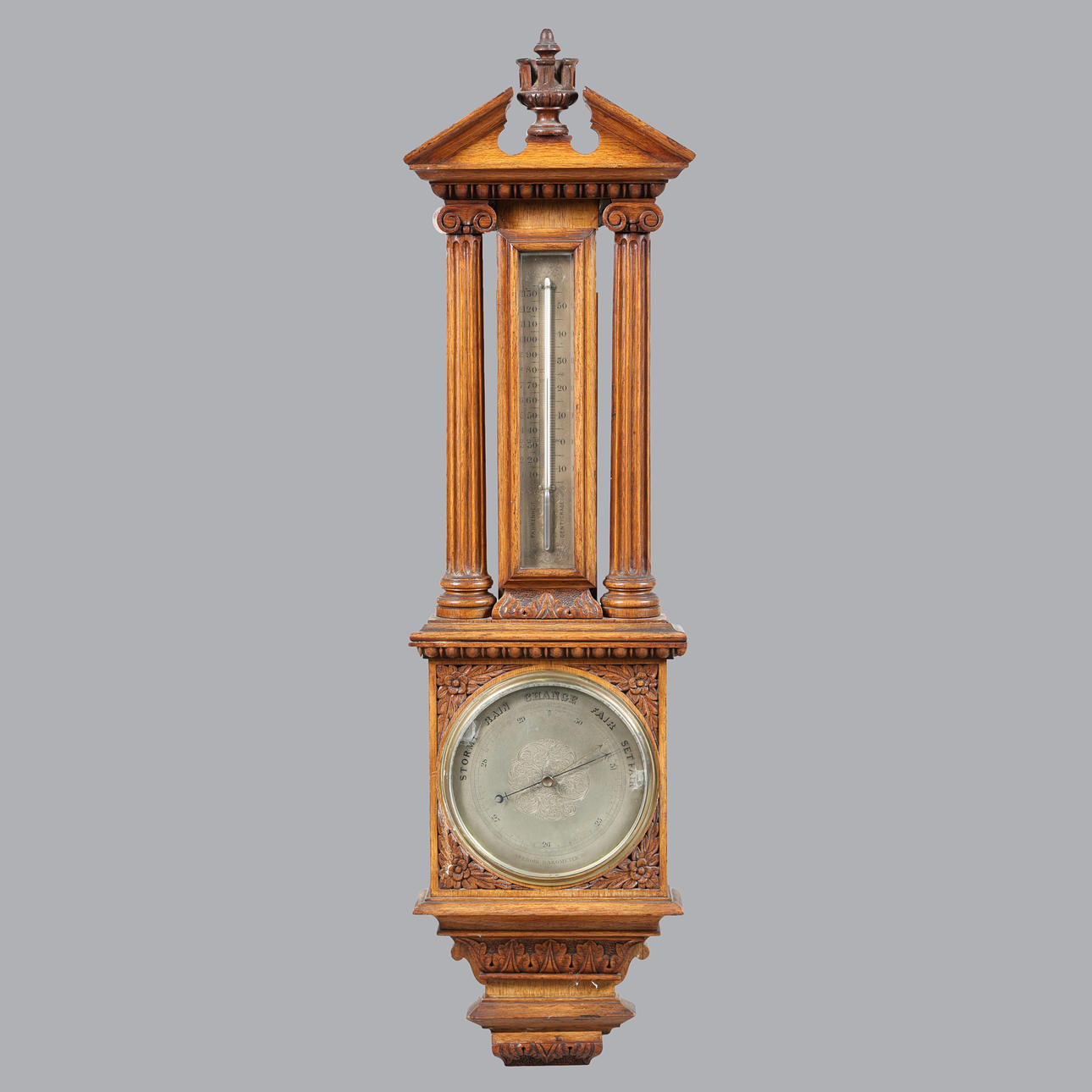 A LATE VICTORIAN GOLDEN OAK ANEROID BAROMETER.