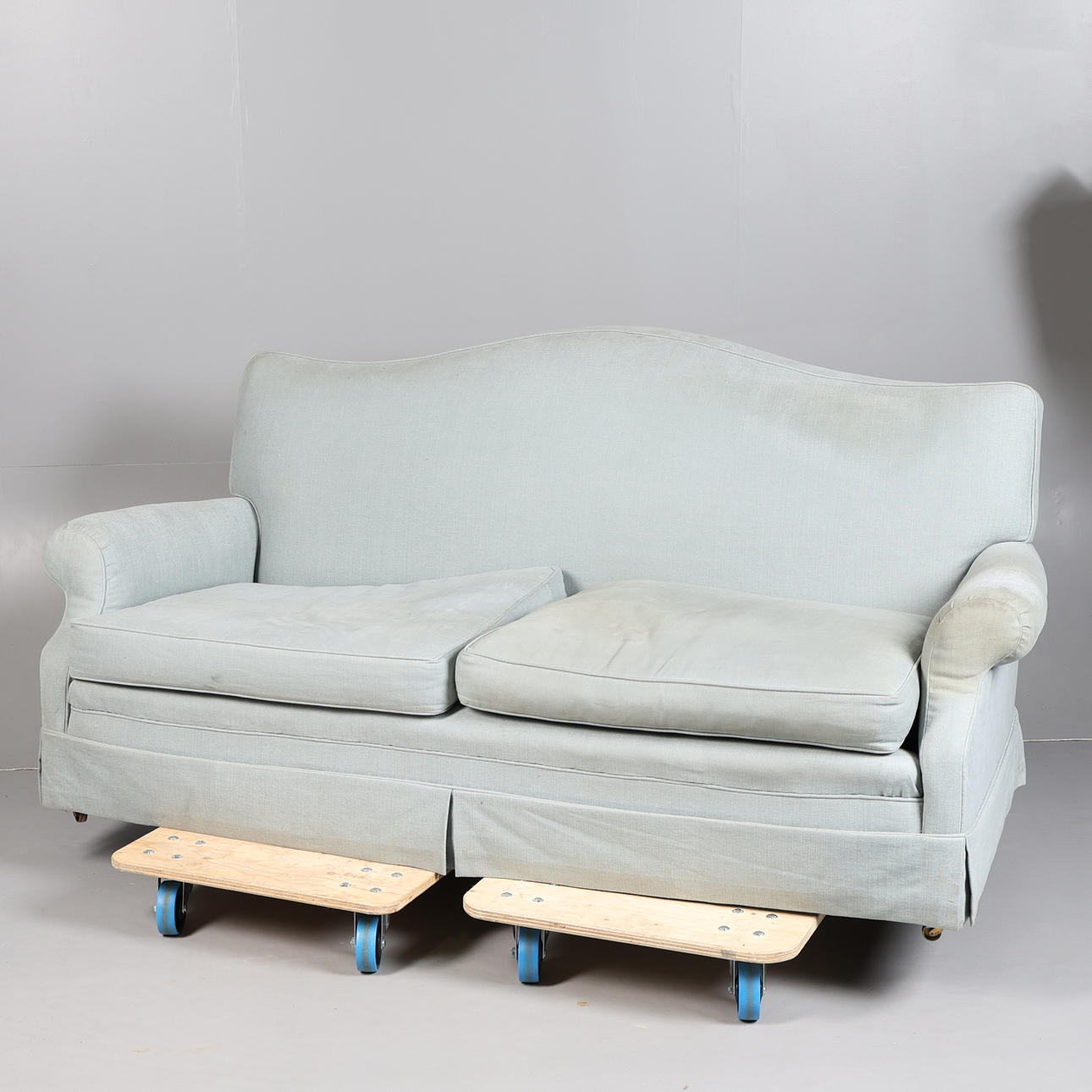 A BLUE/GREY UPHOLSTERED SOFA.