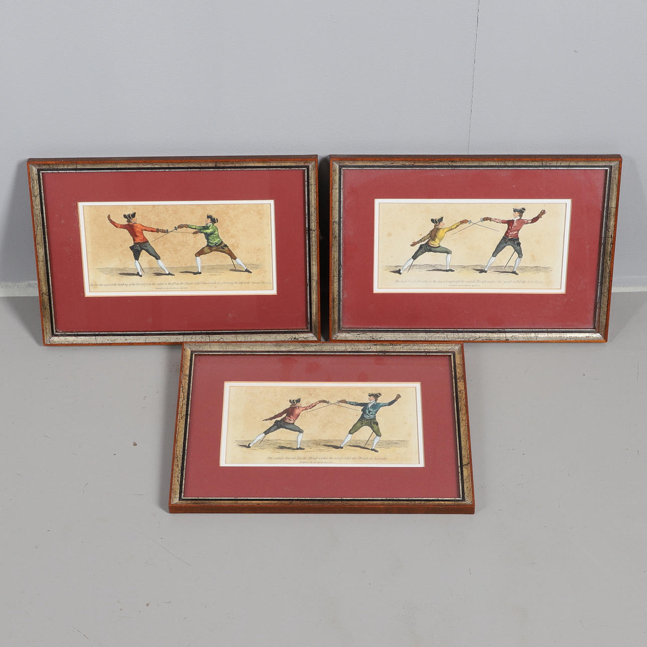 A SET OF THREE 18TH CENTURY HAND-COLOURED FENCING ENGRAVINGS.