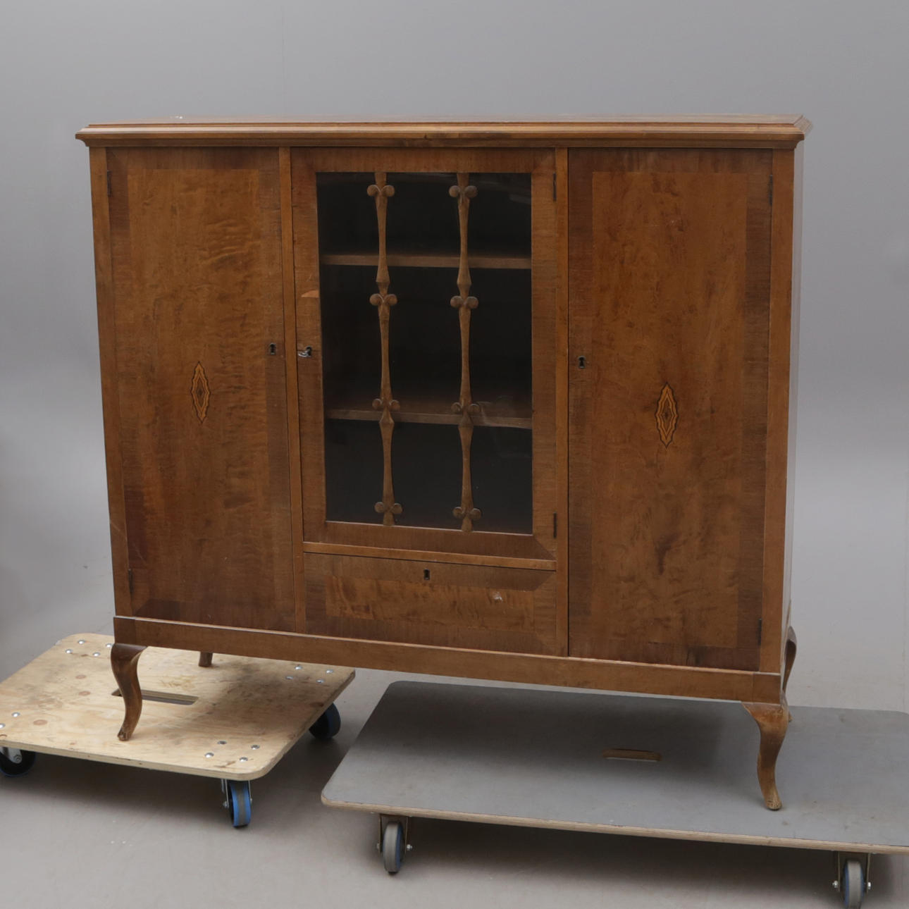 A 1930s intarsia display cabinet.