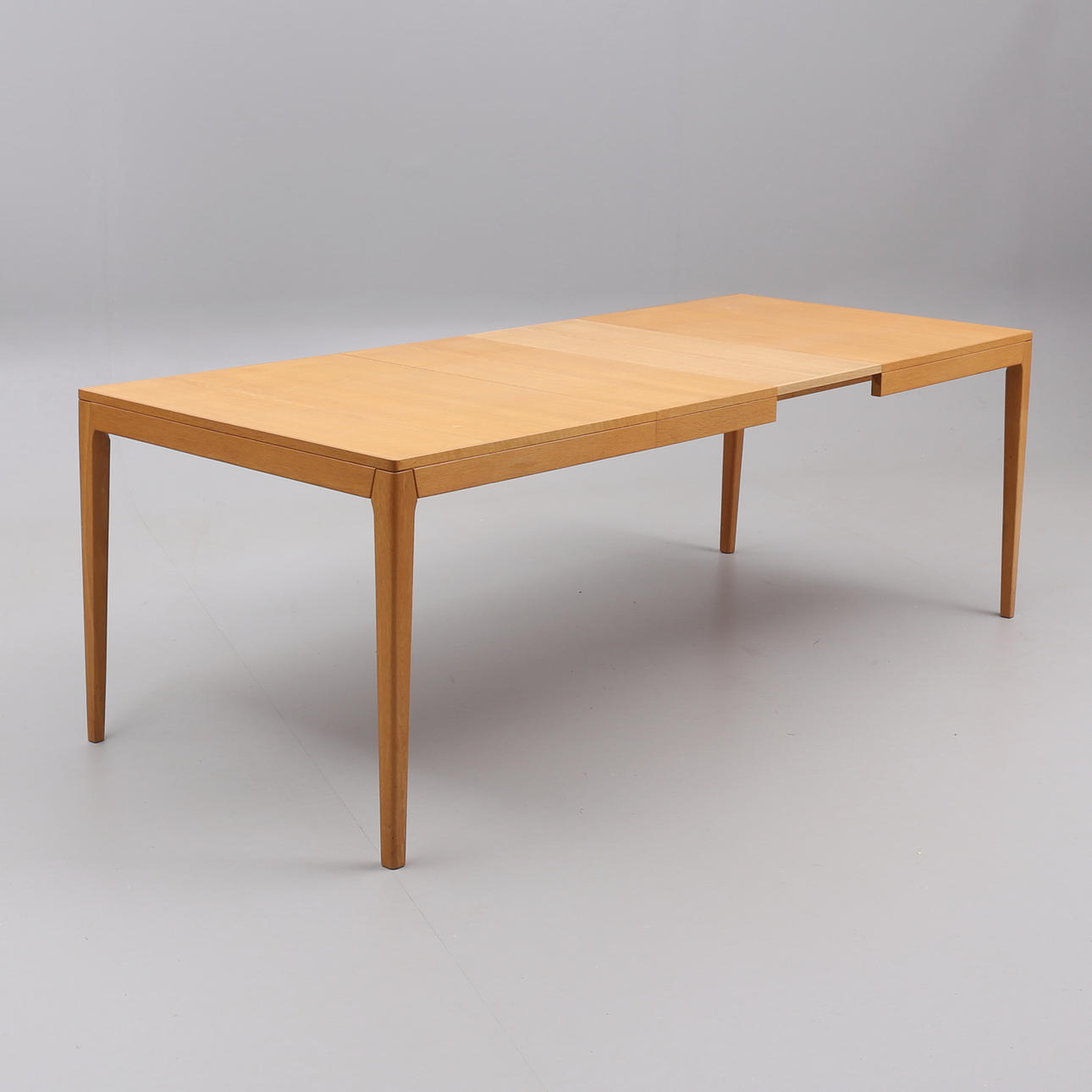 A dining table, oak, with extra boards, later part of the 20th century.