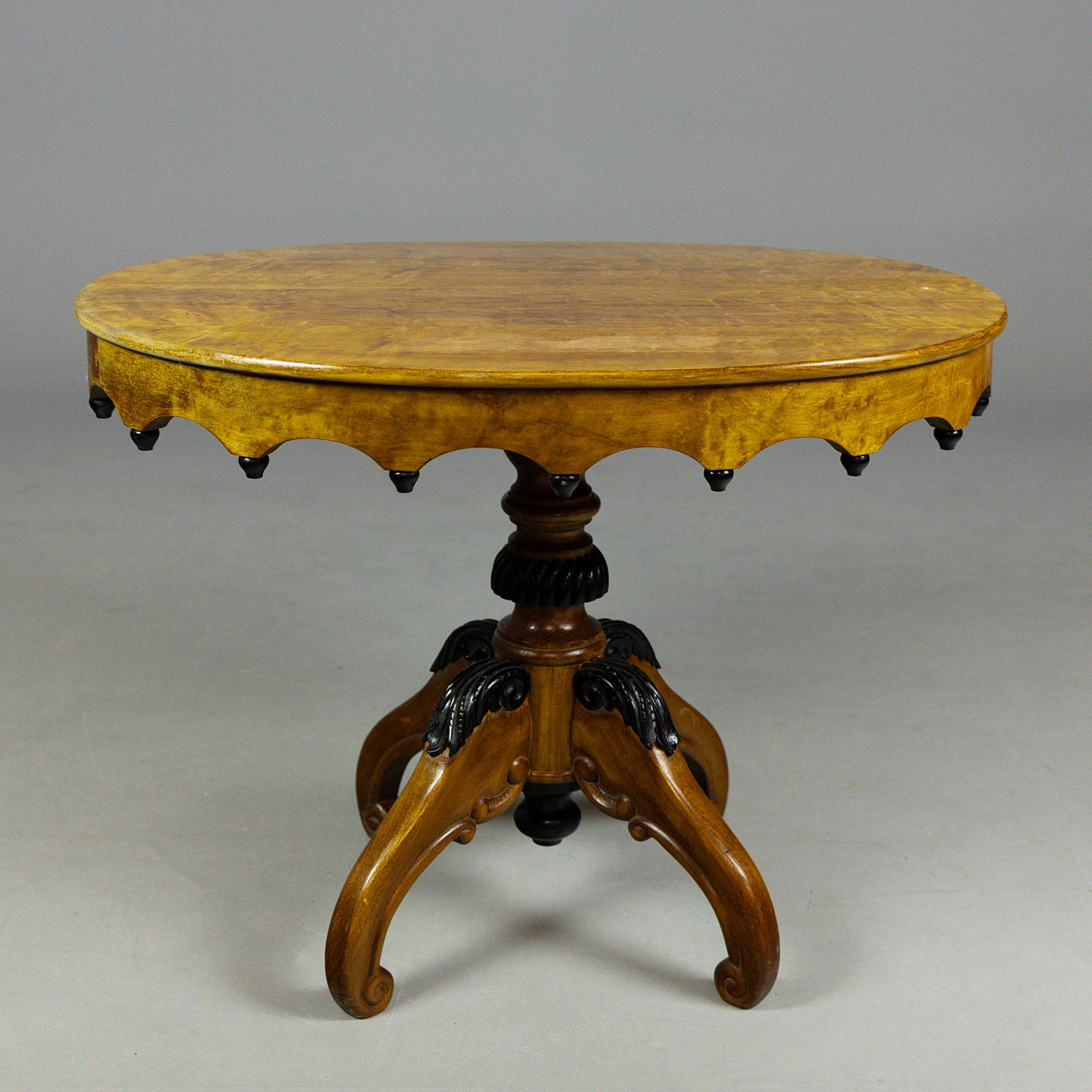 CENTER TABLE WITH SHAPED APRON TOP.