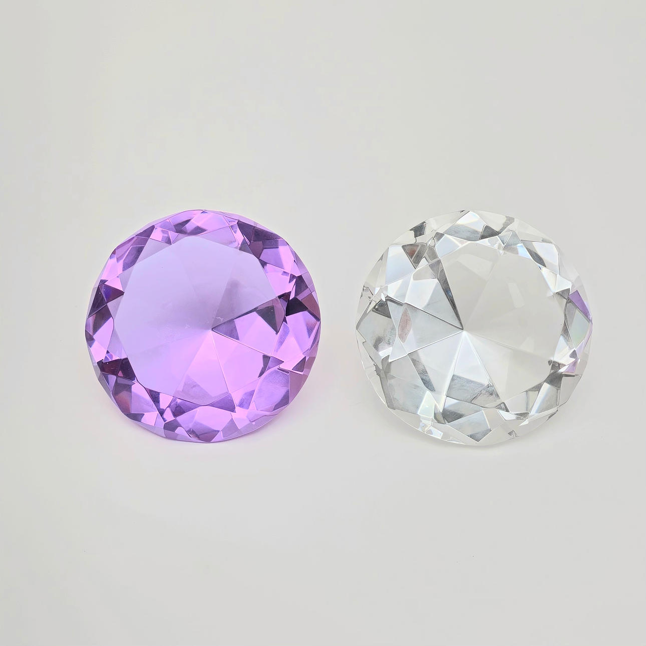 TWO TRANSLUCENT CRYSTAL DIAMONDS AND AMETHYST.