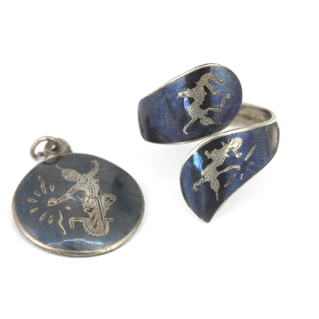 TWO SILVER SIAMESE PIECES.