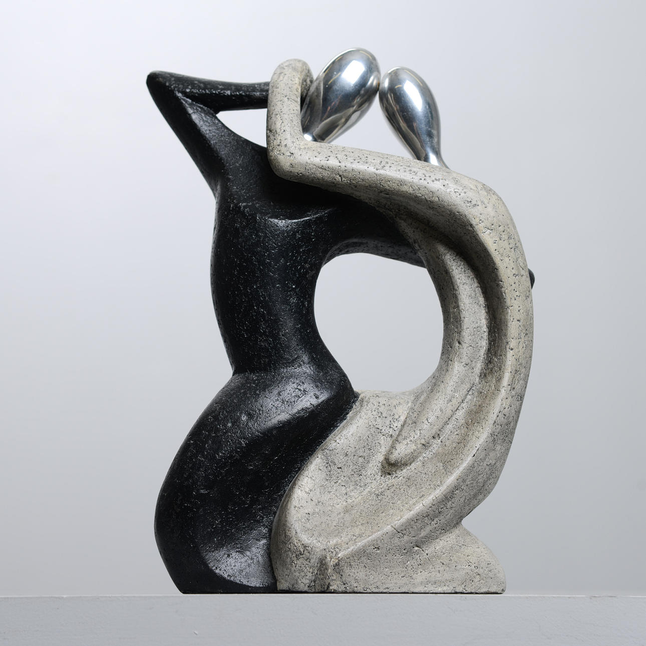 A figurine, concrete & metal, 2000's.