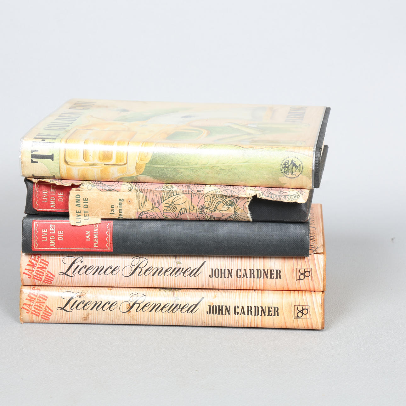 IAN FLEMING, THREE JAMES BOND NOVELS AND TWO BY JOHN GARDNER, ONE SIGNED BY DESMOND LLEWELYN (Q) (5).