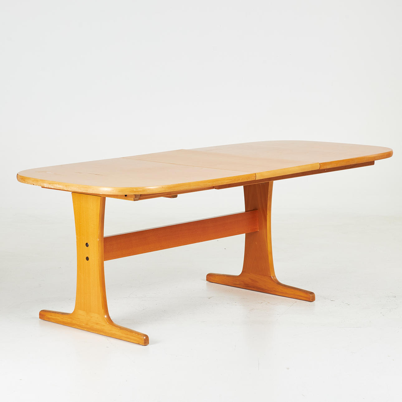 A late 20th century dining table, stained beech.