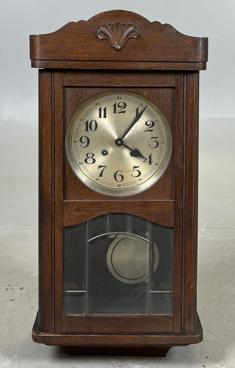 A 1940s oak wall clock.