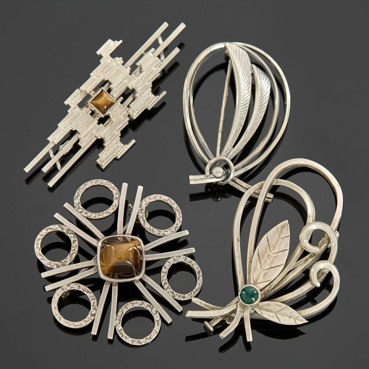 BROOCHES, 4 pcs, silver, abstract shapes with openwork decor, tiger eye, chrysoprase, among others Kordes & Lichtenfels, Ge-Kå-Smyckek G Kaplan, Germany, Sweden.