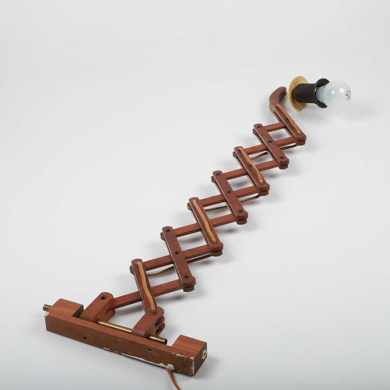 A teak scissor lamp, 20th century.