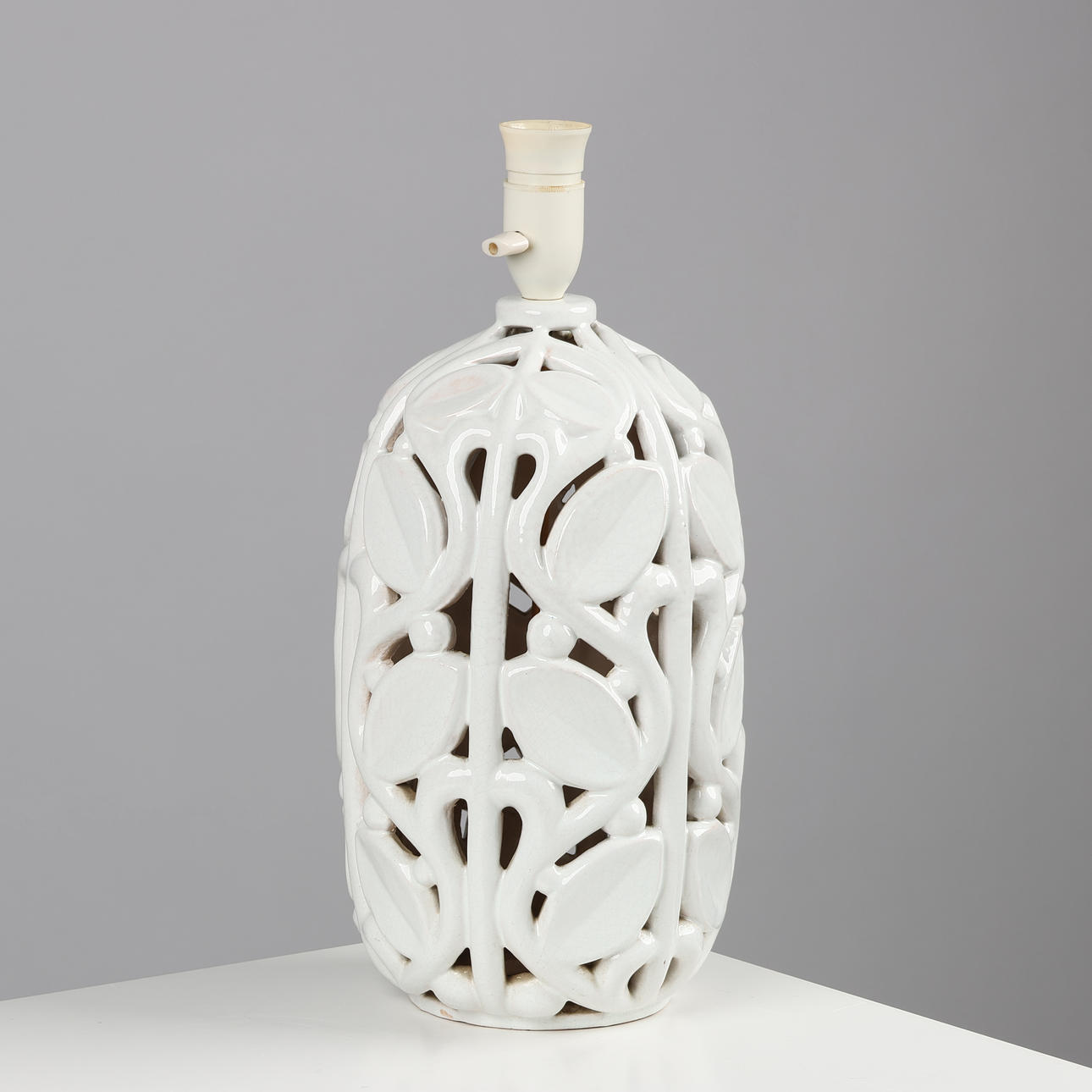 MICHAEL ANDERSEN & SØN, a table lamp with botanical relief in white cracker glaze, Denmark, mid 20th century.