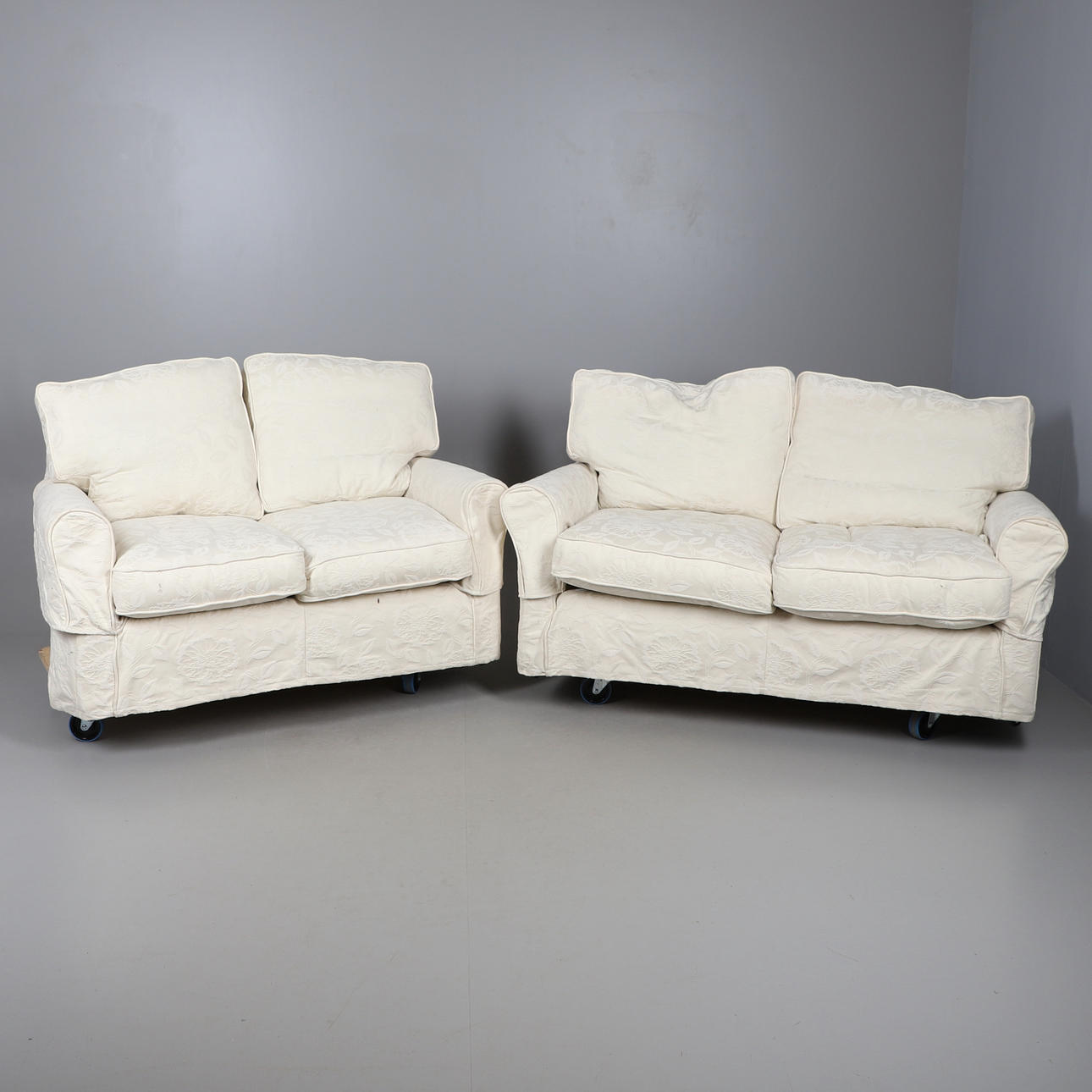 TWO MATCHING TWO-SEATER SETTEES.