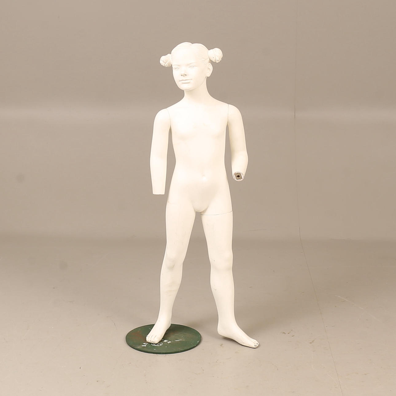 A 20th century mannequin on a stand.