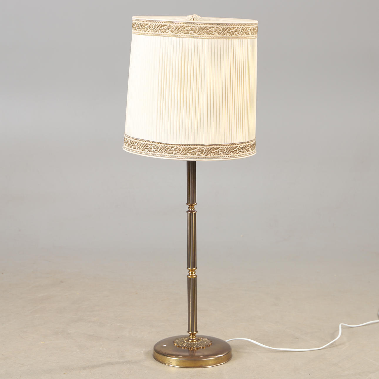 A metal table lamp with textile shade, 20th century.