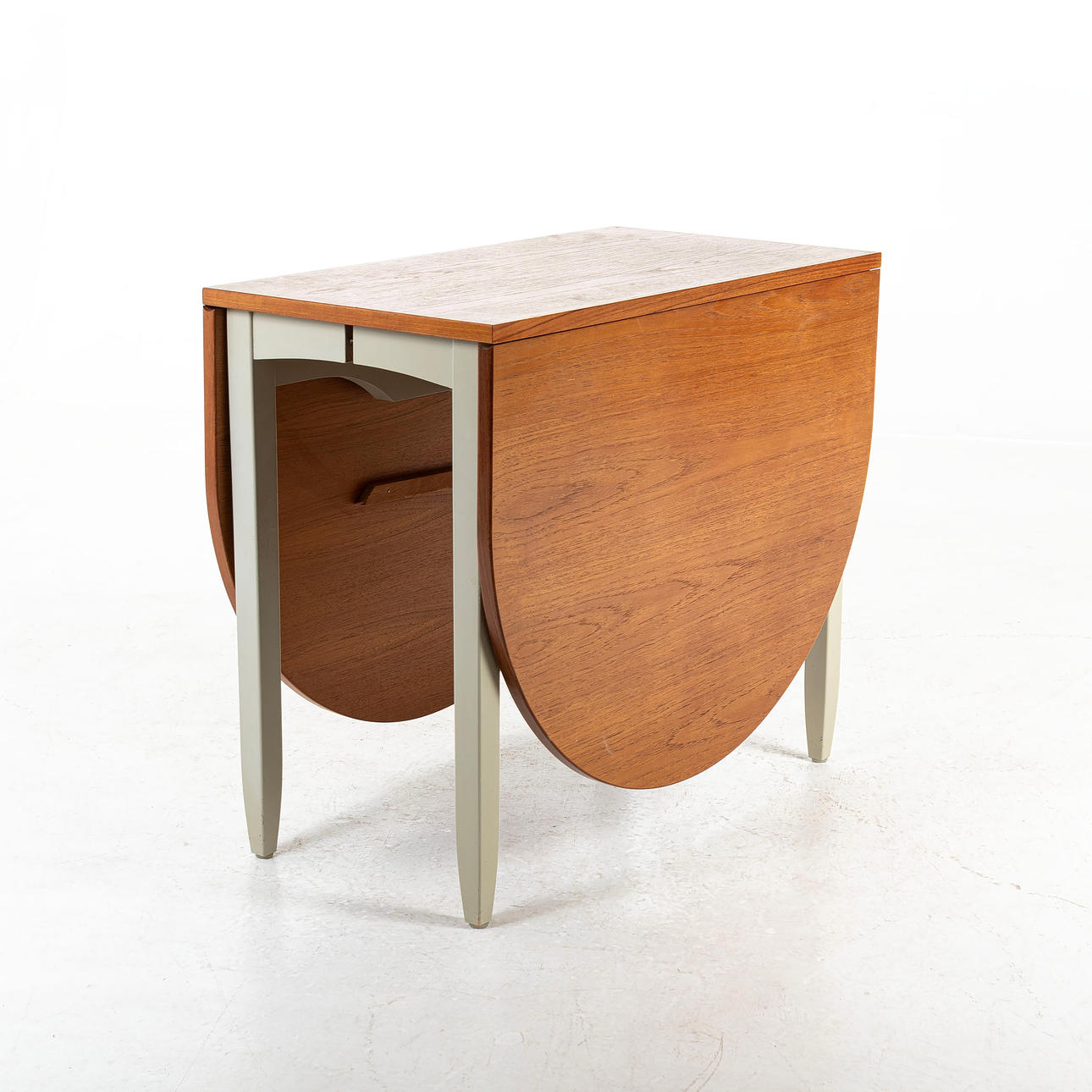 A teak dining table with flaps, circa mid 20th century.
