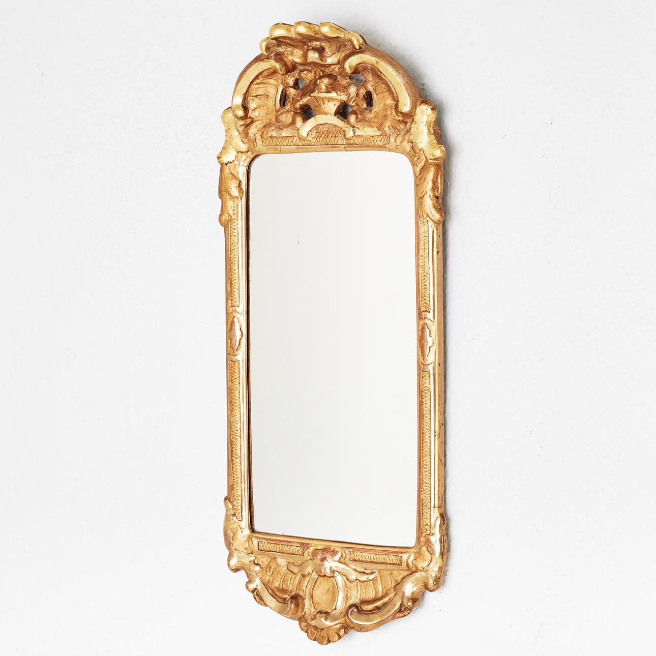 A rococo style mirror, marked John Lundmark, 20th century, bronzed and gilded, decor in pastellage.