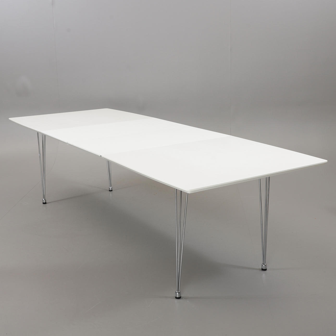 A 21st-century laminate/chrome dining table.