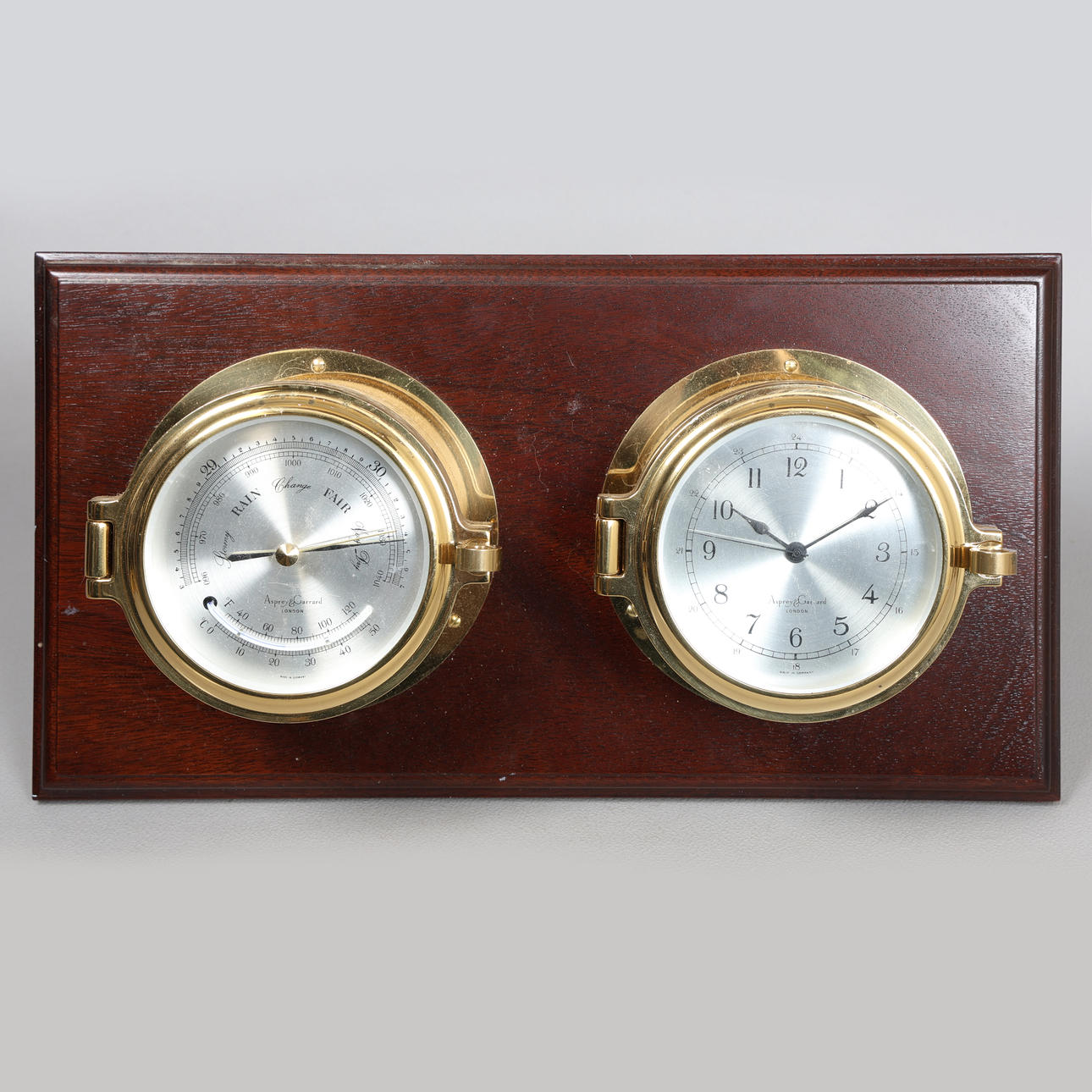 AN ASPREY & GARRARD CLOCK AND BAROMETER SET.