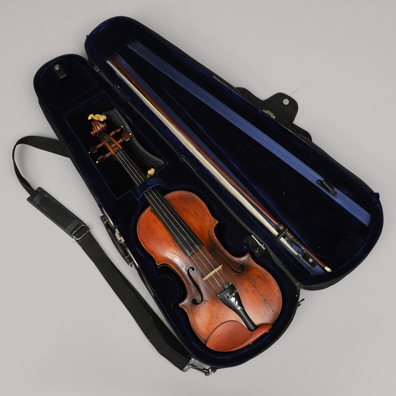 A 19th century violin with string in case.