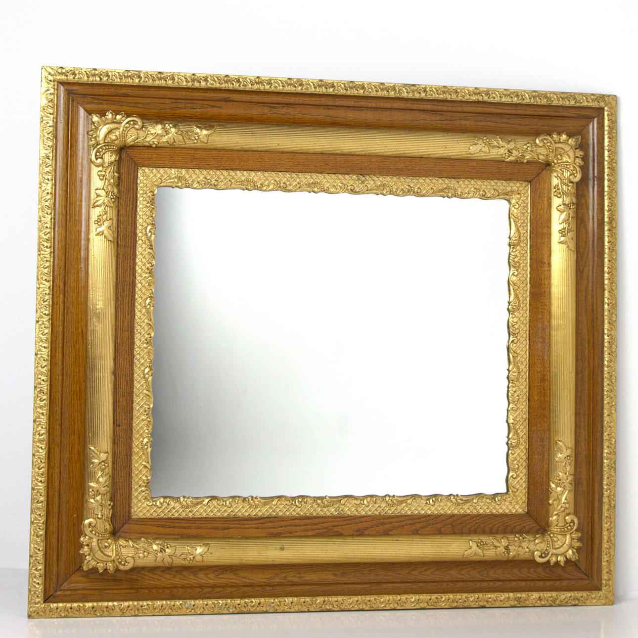 A 20th century pastel oak mirror.