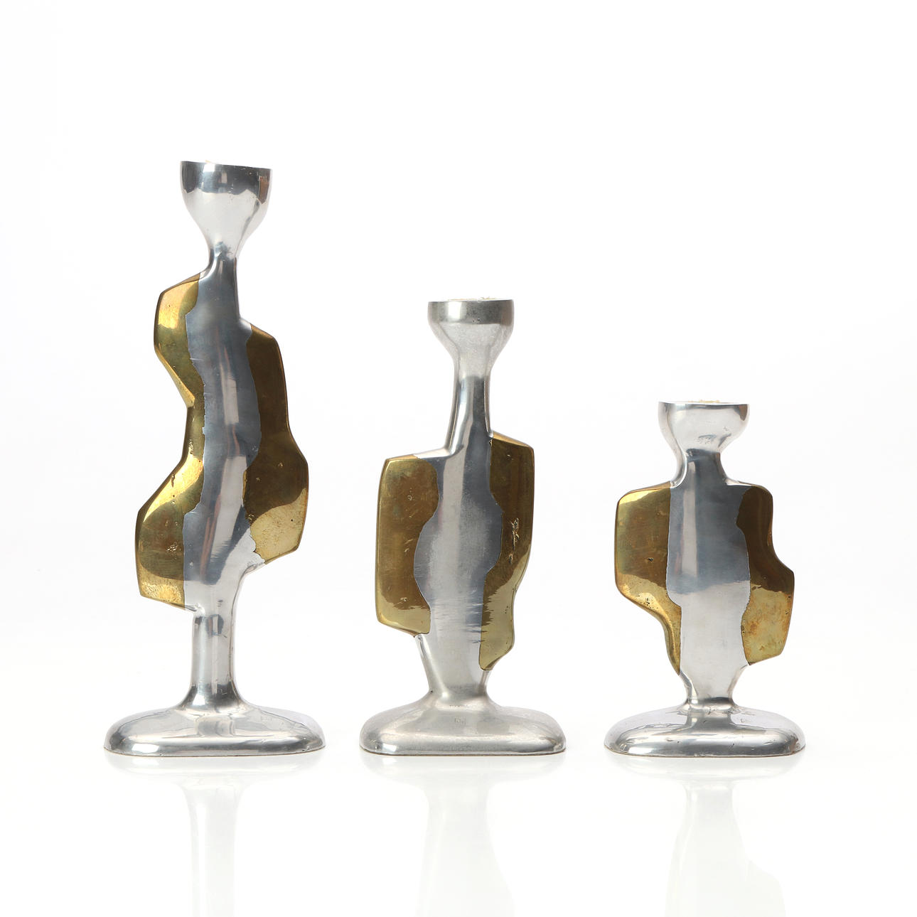 DAVID MARSHALL-DISEÑOS. CANDLESTICKS, THREE PCS. Aluminum and brass. Spain, second half of the 20th century. Marked underneath.