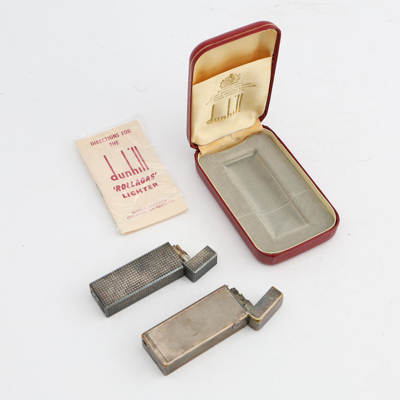 Two Dunhill “Rollagas” and Colibri “John Sterling” lighters, second half of the 20th century, silver-plated metal.