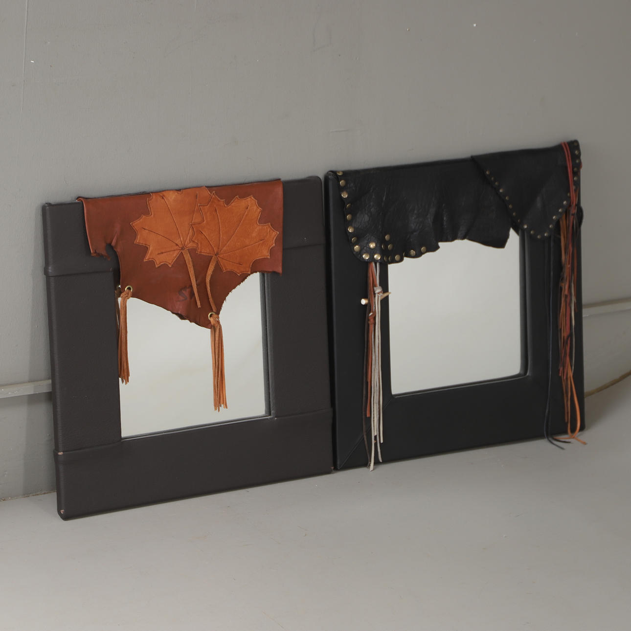 MIRRORS, 2 pieces, leather-clad, dated 2012.