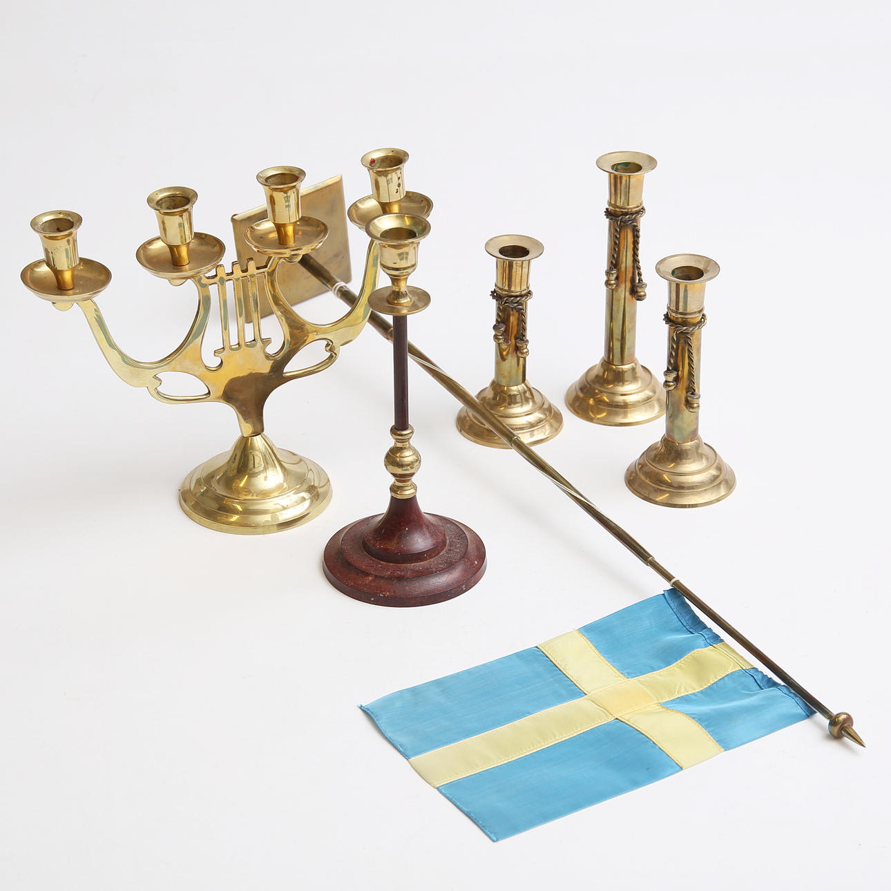 A 20th century brass candlestick and a table flag.